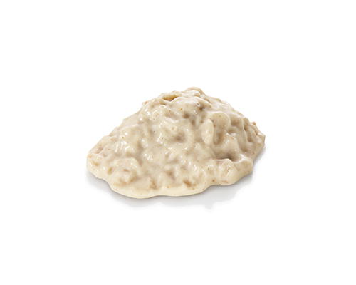Bircher muesli purees yoghurt with apples, oat flakes and sultanas.