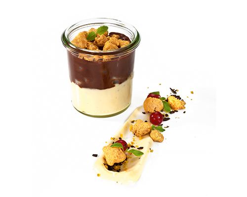 Pear Helene vanilla cream with chocolate sauce, pears and crumble, in a tall preserving jar.
