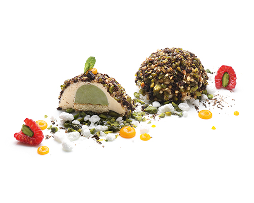 Praline Tartufo Praline mousse with marzipan and creamy pistachio centre on sponge cake, coated with cookies, brittle and pistachios, ø 5 cm.