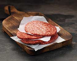 Raw hamburger patty, beef.