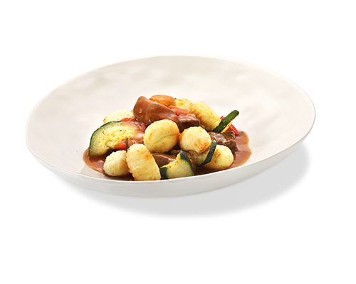 Beef goulash with gnocchi in a typical sauce, with grilled vegetables.