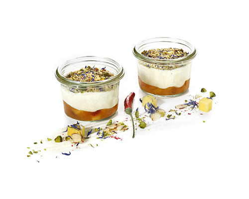 Goat's cheese cream with mango and apricot chutney and cornflower blossom and hazelnut topping.