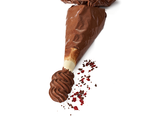 Dunkle Mousse au Chocolat im Spritzbeutel.