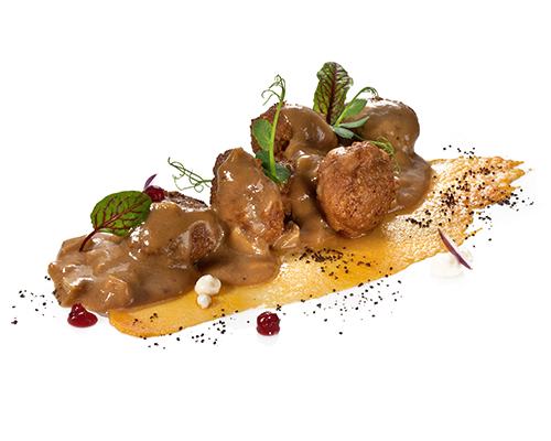 Köttbullar in cream sauce cooked in the classic Swedish style, rounded off with lingonberries.