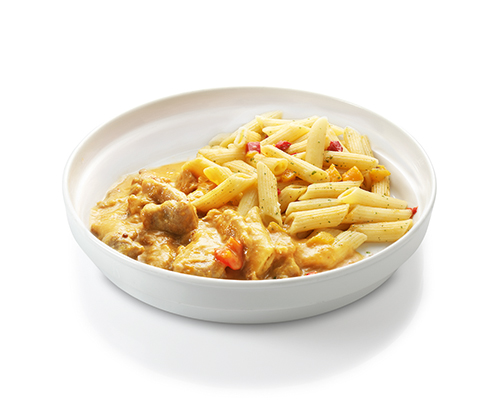 Sliced pork in a peach and pepper sauce with peaches and peppers, served with penne.