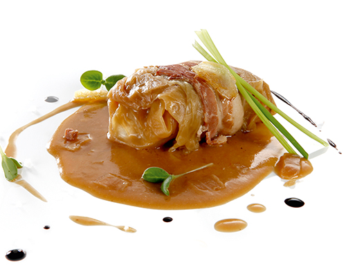 Braised cabbage roulade filled with minced pork, bacon and onions.