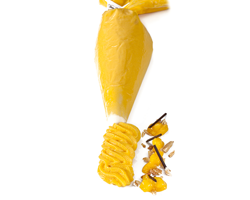 Mango mousse in a piping bag.
