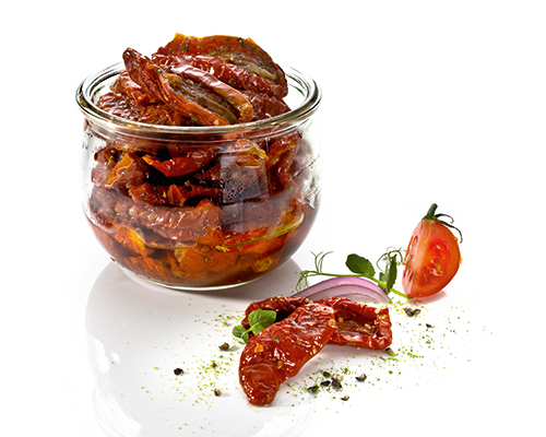 Dried tomatoes in herb and garlic oil.