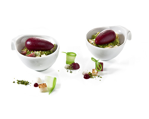 Beetroot gnocchi on celeriac and pastrami salad, in a small cup.