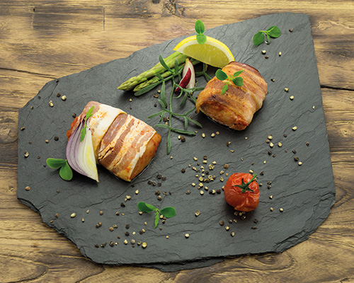 Marinated pollack wrapped in bacon, in a chilli and paprika marinade.