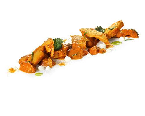 Vegan butter chicken vegan chicken substitute based on pea protein, in a strong curry sauce.