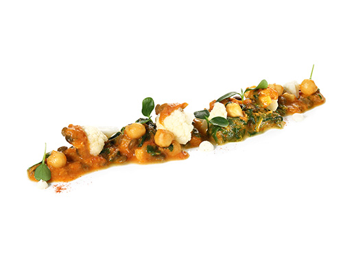 Vegan lentil and cauliflower curry Colourful lentils with cauliflower, chickpeas and spinach, in a vegan curry sauce made from coconut milk and coconut oil