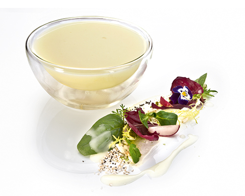 Light-coloured balsamic dressing with light-coloured balsamic vinegar and olive oil.