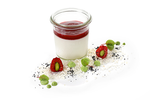 Coconut panna cotta with raspberry sauce on a vegan lentil protein base, in a tall preserving jar.