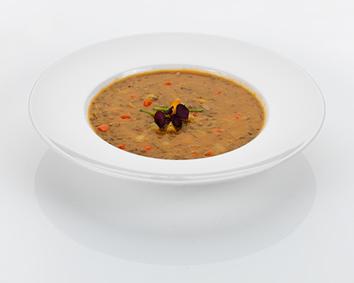 Hearty lentil stew with smoked meat, potatoes and fresh vegetables.