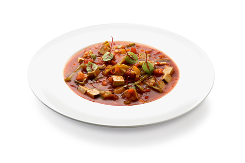 Vegan solyanka classic sweet and sour paprika soup, with smoked tofu, gherkins, carrots and celery.