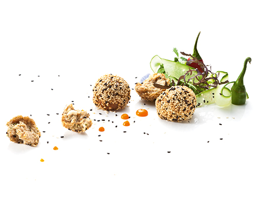 Chicken meatballs with sesame refined with peanut, chilli and ginger.
