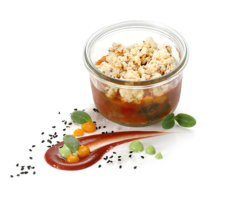 Marinierter Feta auf Gemüsesalat nach griechischer Art, im großen Glas.