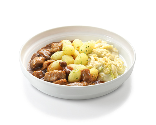 Pork goulash with mushrooms served with potatoes and savoy cabbage in cream.