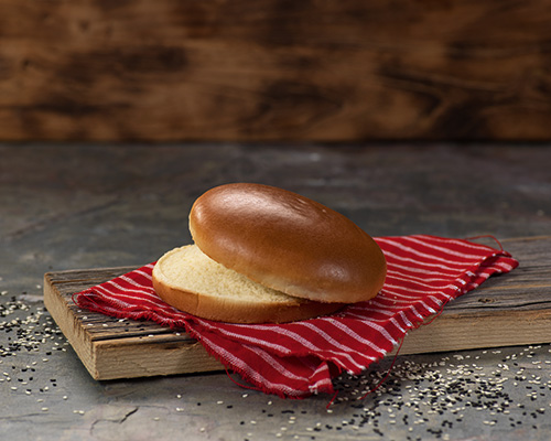 Brioche burger bun. Round yeast pastry, glazed.
