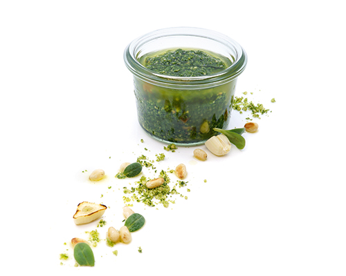 Basilikumpesto mit Olivenöl, frischem Basilikum, Pinienkernen und Hartkäse.