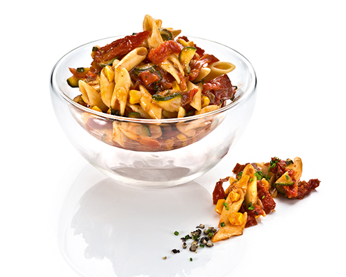 Nudelsalat "Bella Chiao" mit Penne, getrockneten Tomaten, Zucchini und Mais, in würzigem Tomatensugo.
