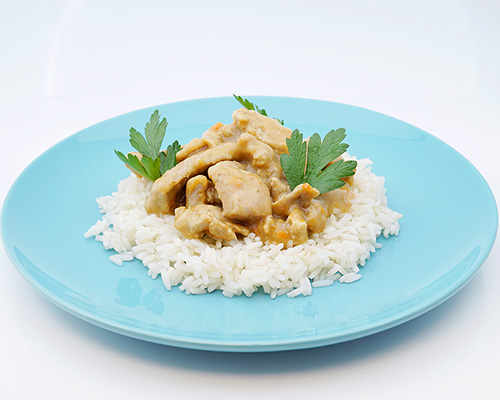 Sliced pork fried in a pan, in a cream sauce.