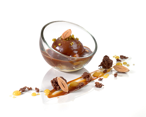 Mousse of roasted nuts with sea salt and mirabelle plums, coated with nougat sauce, in a mini bubble glass.